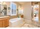 Bathroom featuring a soaking tub with tiled accents and dual vanities at 42293 W Good Vibrations Ln, Maricopa, AZ 85138