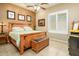 Bedroom with a wooden bed frame, neutral walls and tiled flooring at 42293 W Good Vibrations Ln, Maricopa, AZ 85138