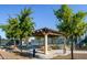Inviting community park featuring a shaded picnic area and tennis courts, perfect for outdoor enjoyment at 42293 W Good Vibrations Ln, Maricopa, AZ 85138