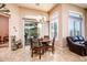 Cozy breakfast nook featuring elegant chandelier and natural light from windows and sliding door at 42293 W Good Vibrations Ln, Maricopa, AZ 85138