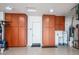 Garage with brown cabinets and concrete flooring at 42293 W Good Vibrations Ln, Maricopa, AZ 85138