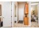 Hallway with various doors, and a cabinet at 42293 W Good Vibrations Ln, Maricopa, AZ 85138