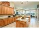 Charming kitchen with wooden cabinets, a central island, and granite countertops at 42293 W Good Vibrations Ln, Maricopa, AZ 85138