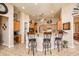 Kitchen bar featuring wooden cabinets, granite countertops, and barstool seating at 42293 W Good Vibrations Ln, Maricopa, AZ 85138