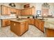 Elegant kitchen with wooden cabinets, central island, and stylish countertops at 42293 W Good Vibrations Ln, Maricopa, AZ 85138