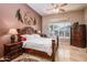 Main bedroom with detailed bed frame, and natural light from the window at 42293 W Good Vibrations Ln, Maricopa, AZ 85138
