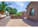 Cozy brick-paved front courtyard surrounded by vibrant desert foliage at 42293 W Good Vibrations Ln, Maricopa, AZ 85138