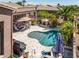 Inviting backyard pool with an outdoor fireplace and covered dining area, perfect for entertaining at 42293 W Good Vibrations Ln, Maricopa, AZ 85138