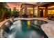 Stunning backyard with a sparkling pool, a waterfall feature, and plenty of space for entertaining at 42293 W Good Vibrations Ln, Maricopa, AZ 85138