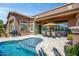 Backyard featuring a pool, covered patio with dining table, and built-in BBQ for outdoor enjoyment at 42293 W Good Vibrations Ln, Maricopa, AZ 85138