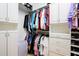 Organized walk-in closet with white cabinets and shelves, providing plenty of storage at 42293 W Good Vibrations Ln, Maricopa, AZ 85138