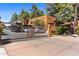 Community entrance with a gated driveway, landscaping, and covered parking available for residents at 4704 E Paradise Village N Pkwy # 236, Phoenix, AZ 85032