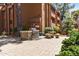 Outdoor grilling area with a stone grill, picnic table, and lush landscaping for entertaining at 4704 E Paradise Village N Pkwy # 236, Phoenix, AZ 85032