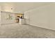 Open-concept living room showcases the kitchen and access to the front door at 4704 E Paradise Village N Pkwy # 236, Phoenix, AZ 85032