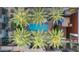 Aerial view of a community pool, palm trees, and outdoor seating areas at 4747 N Scottsdale Rd # 4003, Scottsdale, AZ 85251