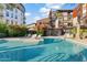 Inviting community pool with lounge chairs, lush landscaping, and a barbecue area at 4747 N Scottsdale Rd # 4003, Scottsdale, AZ 85251