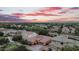 Captivating aerial view of a home featuring lush landscaping and desert sunset at 4756 E Ironhorse Rd, Gilbert, AZ 85297