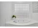 Serene bathroom showcases a luxurious soaking tub with glass block window at 4756 E Ironhorse Rd, Gilbert, AZ 85297