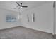 Spacious bedroom featuring neutral walls, carpet, a ceiling fan, and shuttered windows providing natural light at 4756 E Ironhorse Rd, Gilbert, AZ 85297