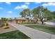 Well-maintained community grounds featuring a path, trees, and view of the clubhouse and pond at 4756 E Ironhorse Rd, Gilbert, AZ 85297