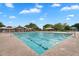 Large community pool with ample seating and umbrellas for relaxing poolside at 4756 E Ironhorse Rd, Gilbert, AZ 85297