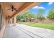 Relaxing covered patio overlooking a spacious backyard with mature trees at 4756 E Ironhorse Rd, Gilbert, AZ 85297