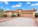 Charming single-story home with a well-manicured yard, concrete driveway and a tile roof at 4756 E Ironhorse Rd, Gilbert, AZ 85297