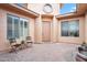 Cozy courtyard with neutral stucco walls, brick floor, and a charming water fountain feature at 4756 E Ironhorse Rd, Gilbert, AZ 85297