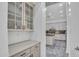 Stylish butler's pantry hallway leading to a modern kitchen with stainless steel appliances at 4756 E Ironhorse Rd, Gilbert, AZ 85297