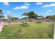 Community picnic area with tables, benches, and shade umbrellas on a well-kept lawn at 4756 E Ironhorse Rd, Gilbert, AZ 85297