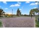 Sand volleyball court in a community park, with net, benches and beautiful trees around it at 4756 E Ironhorse Rd, Gilbert, AZ 85297