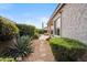 Backyard featuring gravel landscaping, lush green bushes, and a charming walkway to the patio at 4819 E Villa Theresa Dr, Scottsdale, AZ 85254