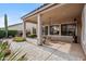 Charming covered patio with views of the beautiful backyard landscaping and desert scenery at 4819 E Villa Theresa Dr, Scottsdale, AZ 85254