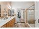 Ensuite bathroom features double sinks, large mirrors, and a glass-enclosed shower with a tiled surround at 4819 E Villa Theresa Dr, Scottsdale, AZ 85254