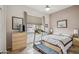 Spare bedroom with neutral decor, light-colored wooden furniture, ceiling fan, and a view of the front yard at 4819 E Villa Theresa Dr, Scottsdale, AZ 85254