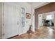 Entryway featuring tile floors, white walls, a decorative giraffe, and an adjoining office at 4819 E Villa Theresa Dr, Scottsdale, AZ 85254