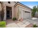 A single-story home featuring a tiled roof, two-car garage, desert landscaping, and a covered entryway at 4819 E Villa Theresa Dr, Scottsdale, AZ 85254