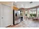 Eat-in kitchen includes stainless appliances and a wine fridge, with an adjacent breakfast nook surrounded by windows at 4819 E Villa Theresa Dr, Scottsdale, AZ 85254