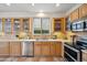 Bright kitchen showcases stainless steel appliances, lots of counter space, and light wooden cabinetry with glass-front uppers at 4819 E Villa Theresa Dr, Scottsdale, AZ 85254