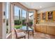 Sunlit breakfast nook featuring tile floors, a glass-top table, and a large window with a garden view at 4819 E Villa Theresa Dr, Scottsdale, AZ 85254