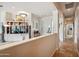 Bright living room features built-in shelving, stylish lighting, and a smooth transition into the hall at 4819 E Villa Theresa Dr, Scottsdale, AZ 85254