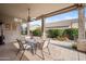 Covered patio with an outdoor ceiling fan and dining set, perfect for enjoying the desert views at 4819 E Villa Theresa Dr, Scottsdale, AZ 85254