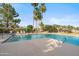Community pool surrounded by lush greenery and palm trees, offering a relaxing retreat at 4819 E Villa Theresa Dr, Scottsdale, AZ 85254