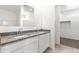 Bright bathroom featuring double sinks with granite countertop and a view of a walk-in closet at 5053 E Umber Rd, San Tan Valley, AZ 85143