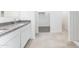 Bright bathroom featuring double sinks with granite countertop and a view of a walk-in closet at 5053 E Umber Rd, San Tan Valley, AZ 85143
