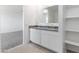 Bright bathroom featuring double sinks with granite countertop and a view of a walk-in closet at 5053 E Umber Rd, San Tan Valley, AZ 85143