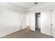 This bedroom features carpeting, a closet with sliding doors, and an electrical outlet at 5053 E Umber Rd, San Tan Valley, AZ 85143
