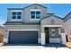 Charming two-story home featuring a gray exterior, a gray garage door, and a welcoming covered entry at 5053 E Umber Rd, San Tan Valley, AZ 85143