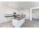 Modern kitchen featuring granite countertops, stainless steel appliances, and an island overlooking the open living space at 5053 E Umber Rd, San Tan Valley, AZ 85143