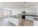 Modern kitchen with stainless steel appliances, granite countertops and center island, ready for cooking at 5053 E Umber Rd, San Tan Valley, AZ 85143